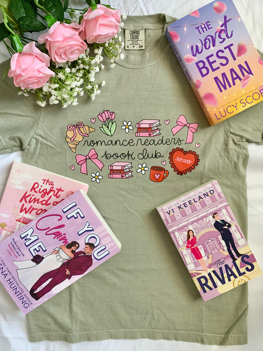Green t-shirt with 'Romance Readers Book Club' design, surrounded by books and flowers on a white surface.